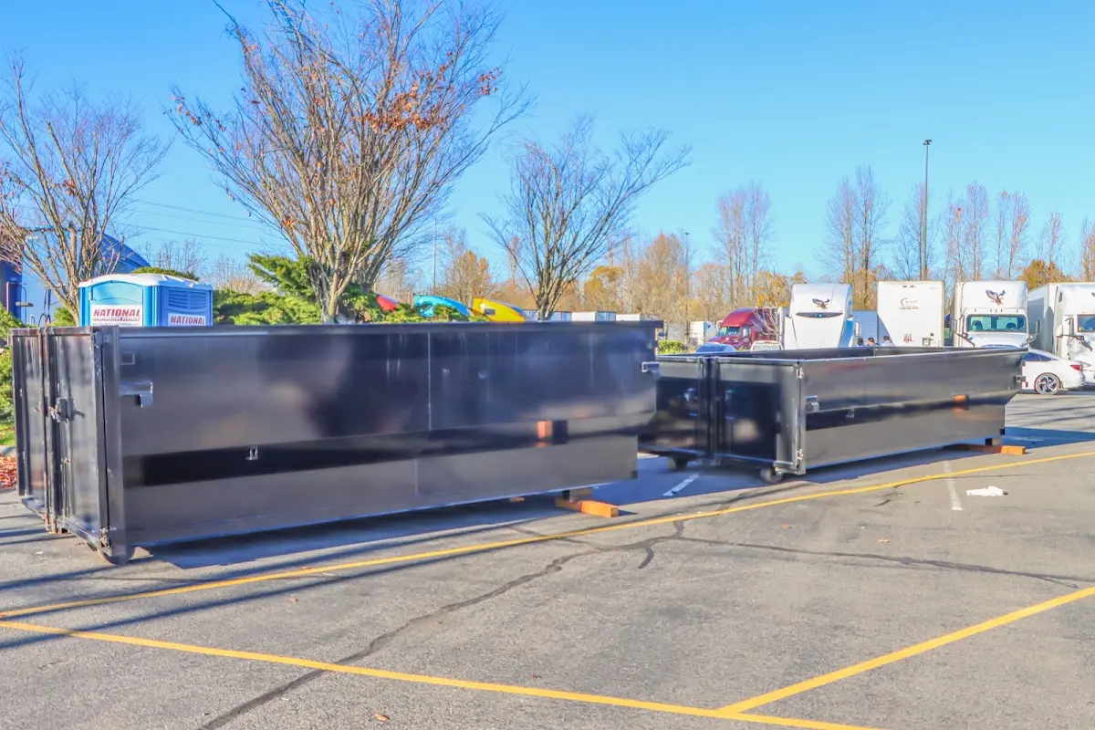 Professional dumpster rental service with roll-off container on residential driveway in Coconut Creek